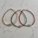Tiny Round Rhodonite Bracelet with 413 Oval Road Sign Charm