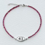 Tiny Round Pink Garnet Bracelet with 413 Oval Road Sign Charm