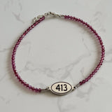 Tiny Round Pink Garnet Bracelet with 413 Oval Road Sign Charm