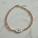 Tiny Round Rhodonite Bracelet with 413 Oval Road Sign Charm
