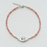 Tiny Round Rhodonite Bracelet with 413 Oval Road Sign Charm